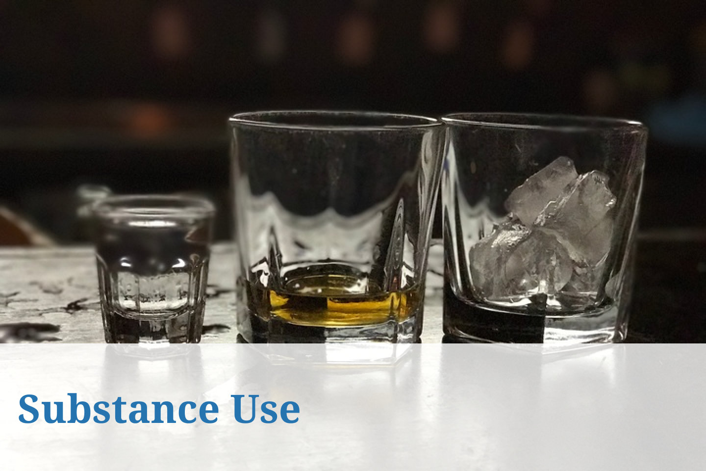 3 whiskey glasses sitting on a bar table
